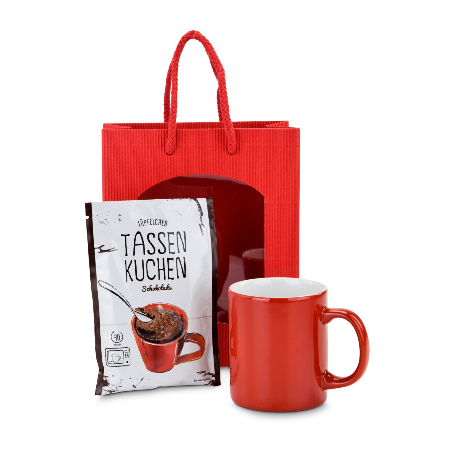 Schnell und lecker: ein Kuchen für zwischendurch - eine rote Geschenktüte, eine rote Tasse und eine Backmischung für einen Tassenkuchen.