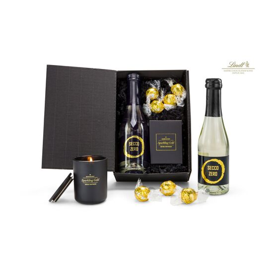Eine edle Präsentation: alkoholfreier Secco (0,2 l), ROMOSCENT® Duftkerze und 4 goldene Lindt Lindorkugeln (je 12,5 g) in schwarzer Box